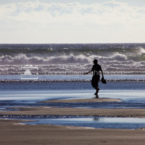 Silhouetted Man Gesturing on the Shoreline
