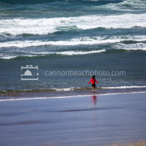 Lady in a Red Jacket Plays in the Surf