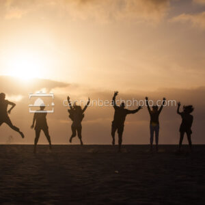 Silhouetted Family Jumping on the Beach 2