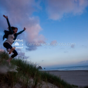 Woman Dune Jumping at Sunset