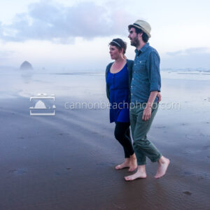 Young Couple Walking on the Evening Sand